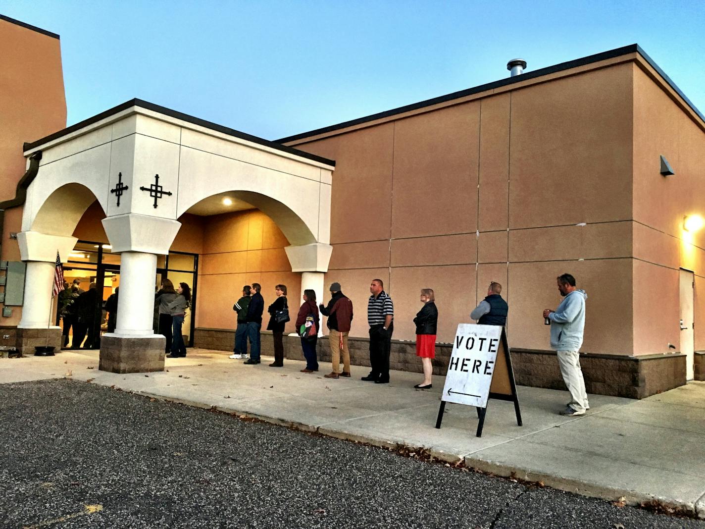 Voters wait in line Tuesday morning to cast their votes in the presidential election at St. George Antiochian Orthodox Church in West St. Paul.