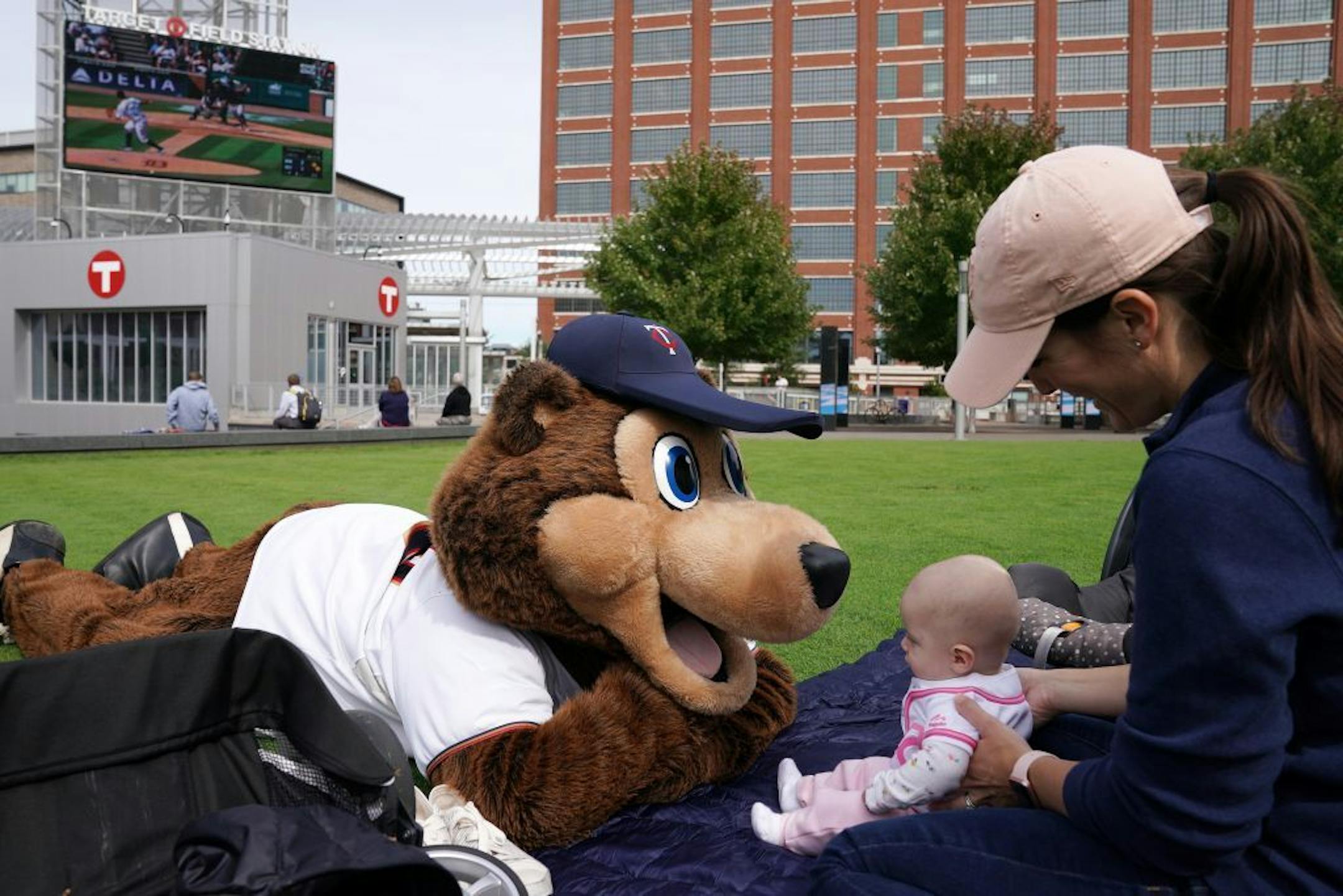 T.C. Bear sat with Chrissie Olson and her 5-month-old daughter during a free "Post-season Push" party to watch the Twins play the Tigers in Detroit Thursday.
