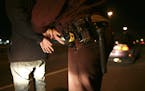 Shortly before 2 a.m. last Saturday morning, Trooper Adam Flynn handcuffs the driver of a vehicle who was allegedly driving while under the influence 