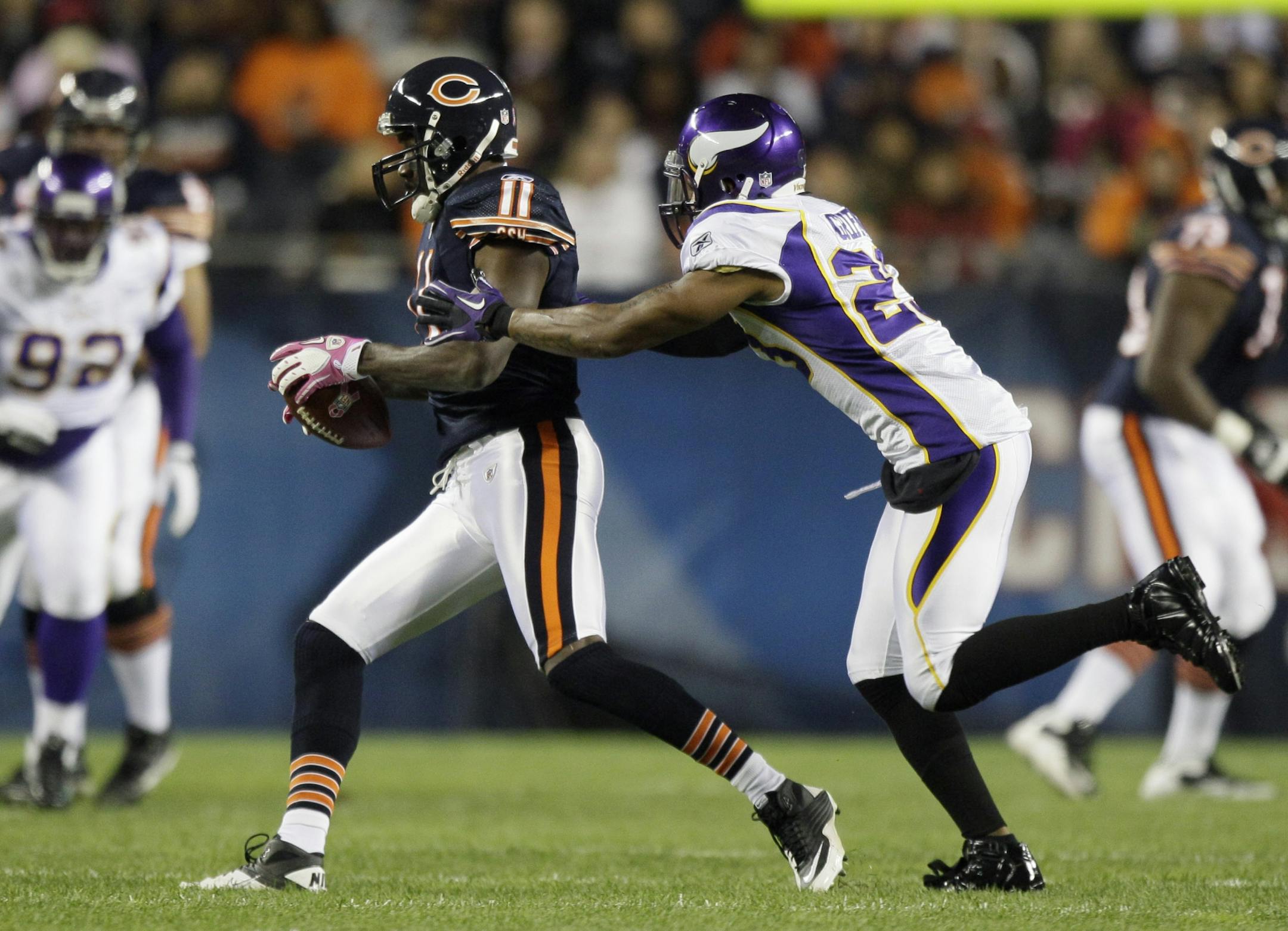 Chicago Bears wide receiver Roy Williams (11) makes a reception while defended by Minnesota Vikings cornerback Cedric Griffin (23) in the first half of an NFL football game in Chicago, Sunday, Oct. 16, 2011.