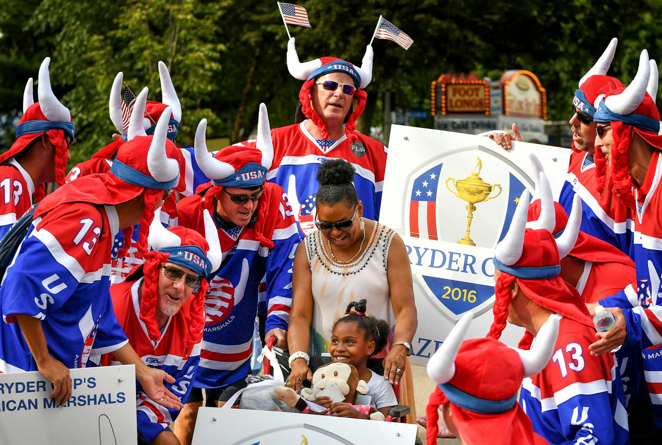 Ryder Cup's American Marshals serenaded Chazity Webb and her Godmother Rochelle, singing "You are my Sunshine." ] GLEN STUBBE * gstubbe@startribune.com Thursday, September 1, 2016 Feature story on the American Marshals, (6-12 folks at the fair today) a group of local fans who have attended recent Ryder Cups. They dress up, cheer, and get rowdy. They are gathering at the State Fair today.