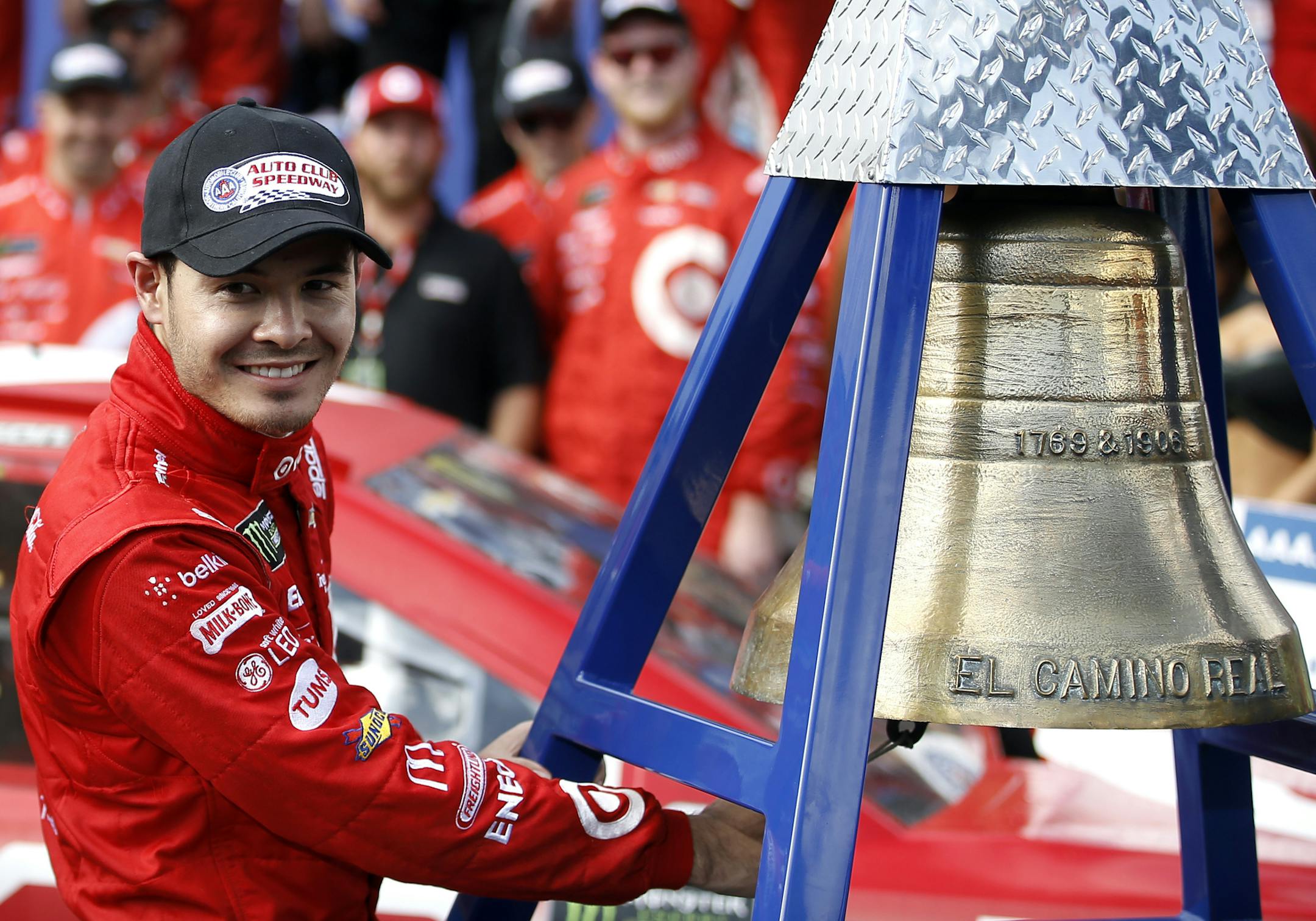 Kyle Larson rings the El Camino Real bell after his win in the NASCAR Cup Series auto race at Auto Club Speedway in Fontana, Calif., Sunday, March 26, 2017. (AP Photo/Alex Gallardo)