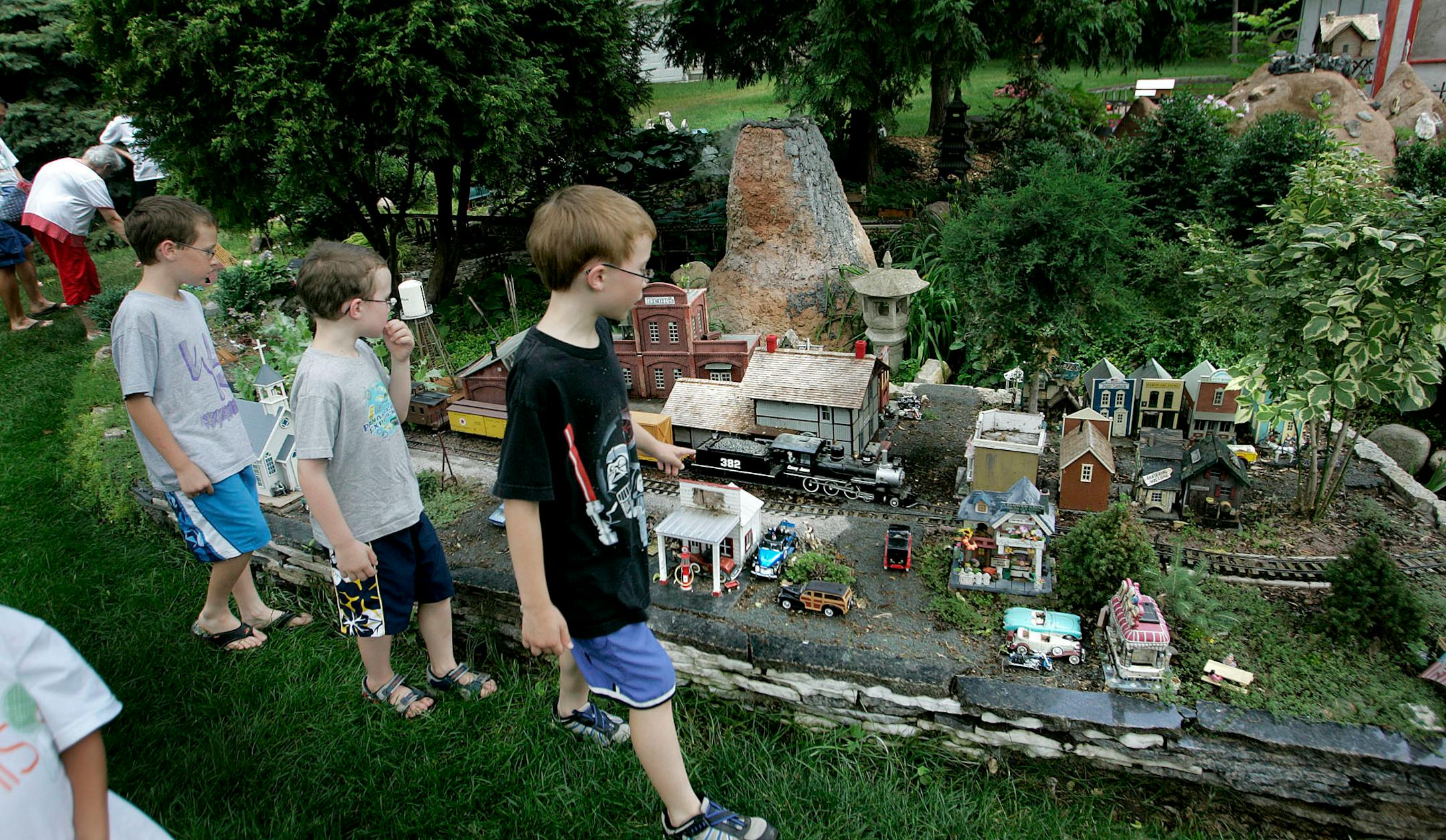 From left: Knox Arnett, 9, Kevin Anderson, 6, and Ryan Anderson, 9, made their way around Bud Lutz's yard-sized train during a tour. Lutz's Eagan railway garden has been featured on national television. He regularly gives tours and has had as many as 400 people in a single day.