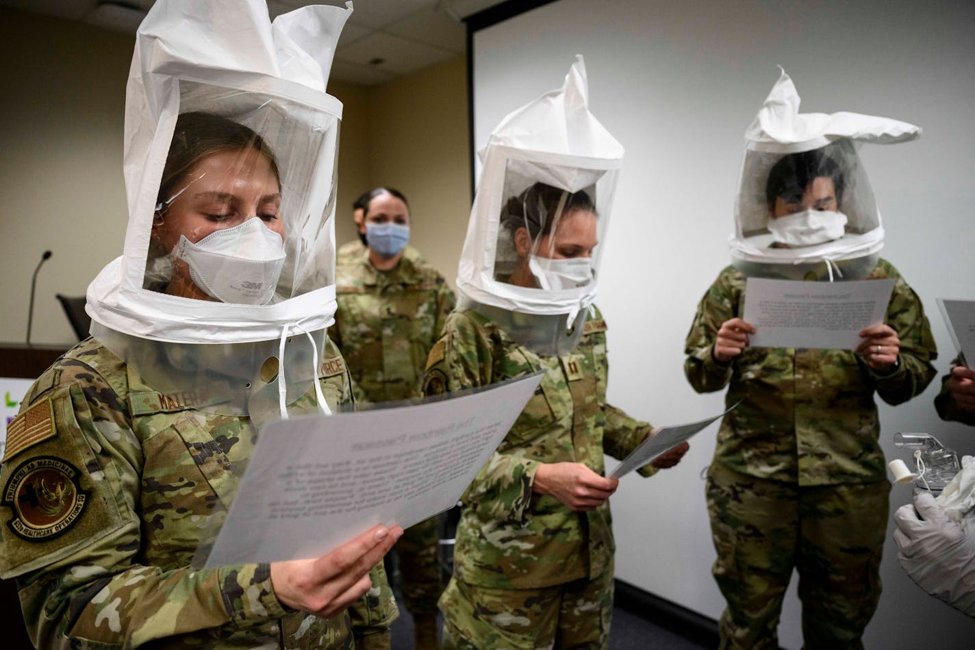 From left, U.S. Air Force Airman 1st Class Shelby Matera and captains Aimee Clonts and Kimbrely Mason took part in an N95 fit check Tuesday, Nov. 23, 2021 at Hennepin County Medical Center in Minneapolis, Minn. The three are part of a medical response team sent to help overburdened hospitals in Minnesota. Minnesota Gov. Tim Walz joined Minnesota Department of Health Commissioner Jan Malcolm and Major General Shawn Manke, the Minnesota National Guard's Adjutant General, to discuss the state's efforts to expand hospital capacity amid the recent surge in COVID-19 patients.