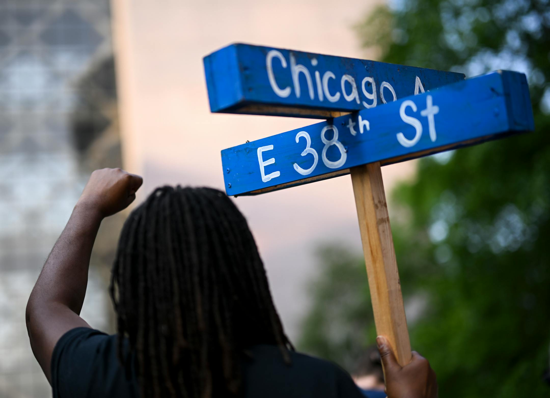 Marcia Howard, a caretaker of George Floyd Square, raises her fist into the air during a rally outside the Hennepin County Government Center Friday, June 16, 2023, in Minneapolis, Minn. The US Department of Justice released the findings in its sweeping investigation into the Minneapolis Police Department finding it routinely engaged in a pattern of racist and abusive behavior.
