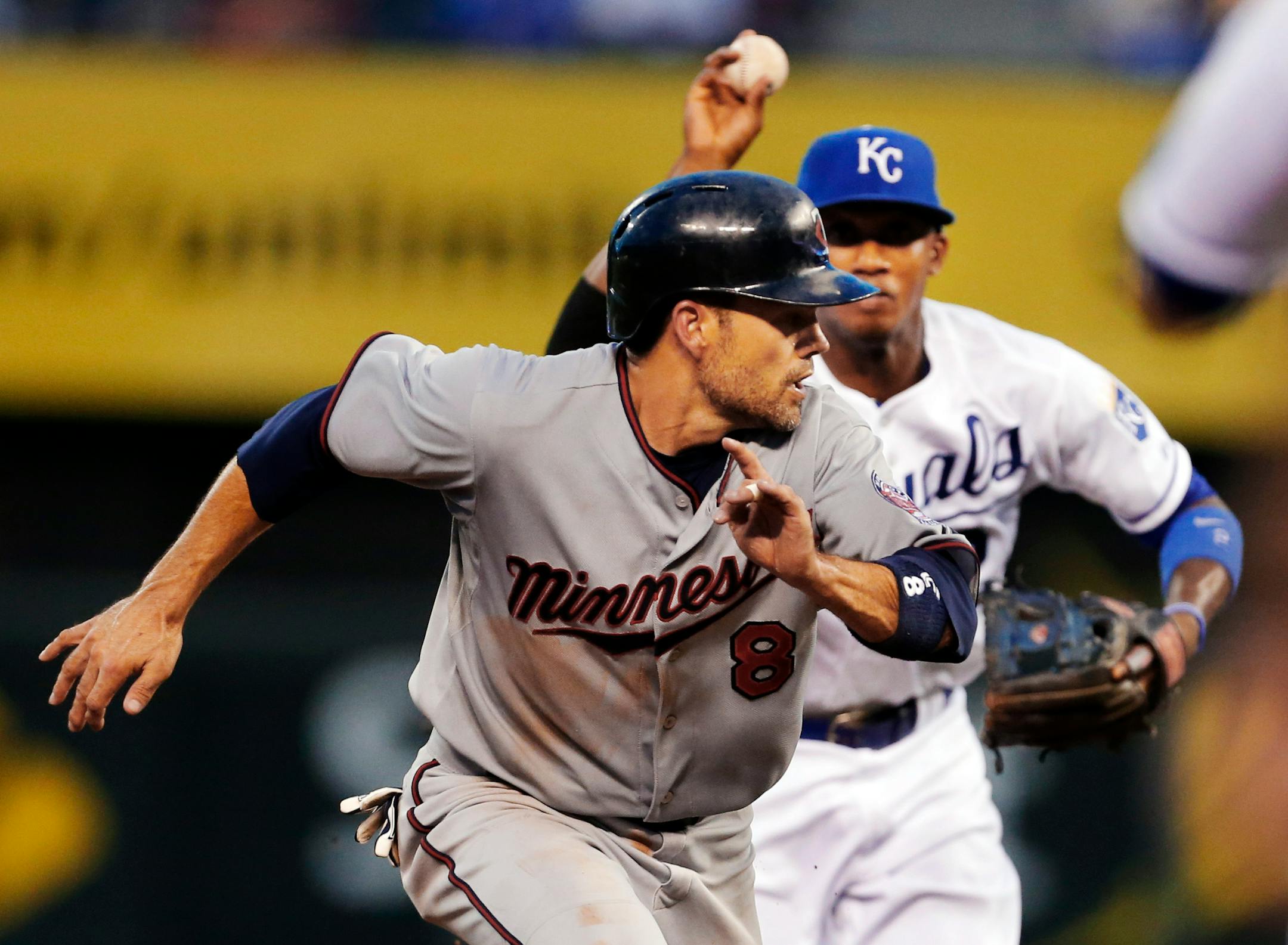 Last week, Twins infielder Jamey Carroll, front, was caught in a rundown against Kansas City. Now, the Royals are his teammates.