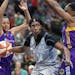 Minnesota Lynx center Sylvia Fowles drives between Los Angeles Sparks players, including Candace Parker, left, during the second half.
