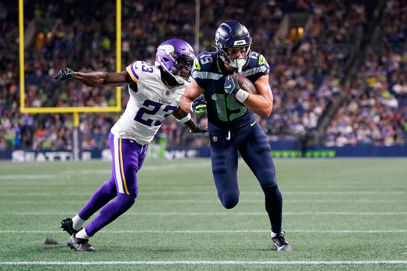 Seahawks wide receiver Jake Bobo ran for a touchdown against Vikings cornerback Andrew Booth Jr. during the second half Thursday night in the preseason opener.