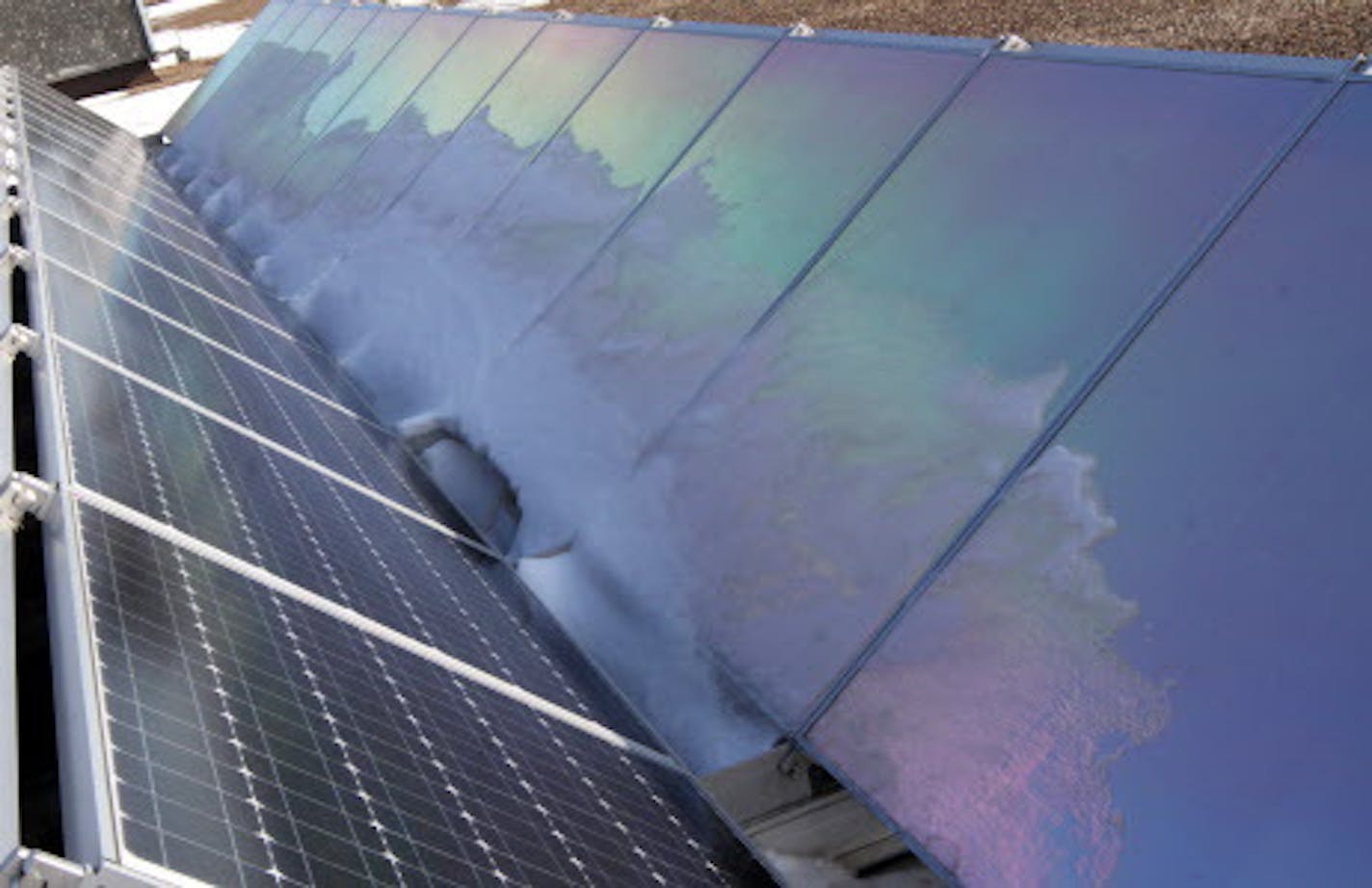 Reflective backs on solar arrays reflected the suns rays. President and Founder of tenKsolar, Dallas Meyer, talked about how how the tenKsolar company solar arrays were designed to work in snow conditions, like those encountered in Minnesota. The solar arrays were mounted on the roof of the Bloomington company headquarters. He was photographed on 1/26/12.] Bruce Bisping/Star Tribune bbisping@citilink.com.