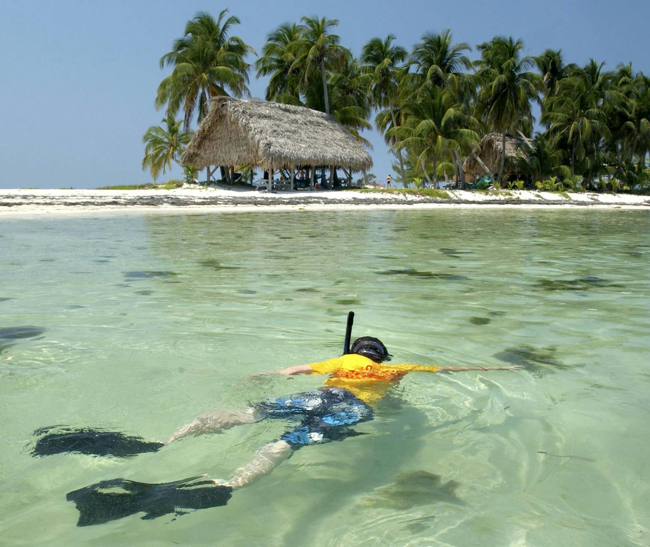 A young boy snorkles off of Ranguana Caye, in March 2005, a small island off the coast of Placencia, Belize, a beach town in the southern part of the country. The tiny country of Belize, a little smaller than Massachusetts, has caught the collective eye of vacationing hordes for years.