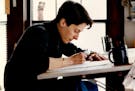 March 16, 1990 Nationally syndicated cartoonist Alison Bechdel, at work in her south Mpls apt. Tom Sweeney