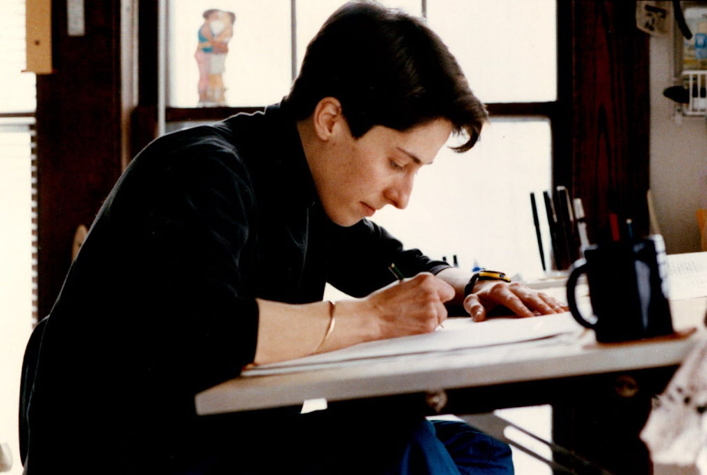 March 16, 1990 Nationally syndicated cartoonist Alison Bechdel, at work in her south Mpls apt. Tom Sweeney