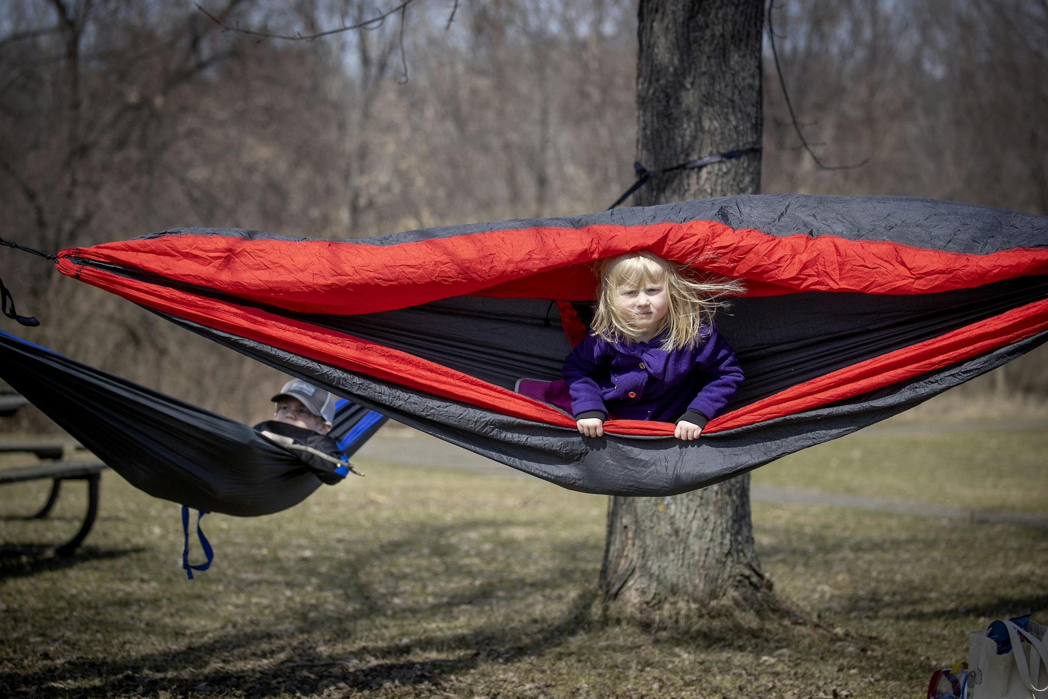 Four-year-old Effie Sahlberg, cq, and her brother Gus Sahlberg, 7, enjoyed the outdoors as their mother Maja Sahlberg pushed them in their portable hammocks before a picnic at Fort Snelling State Park, Monday, March 30, 2020 in St. Paul, MN.