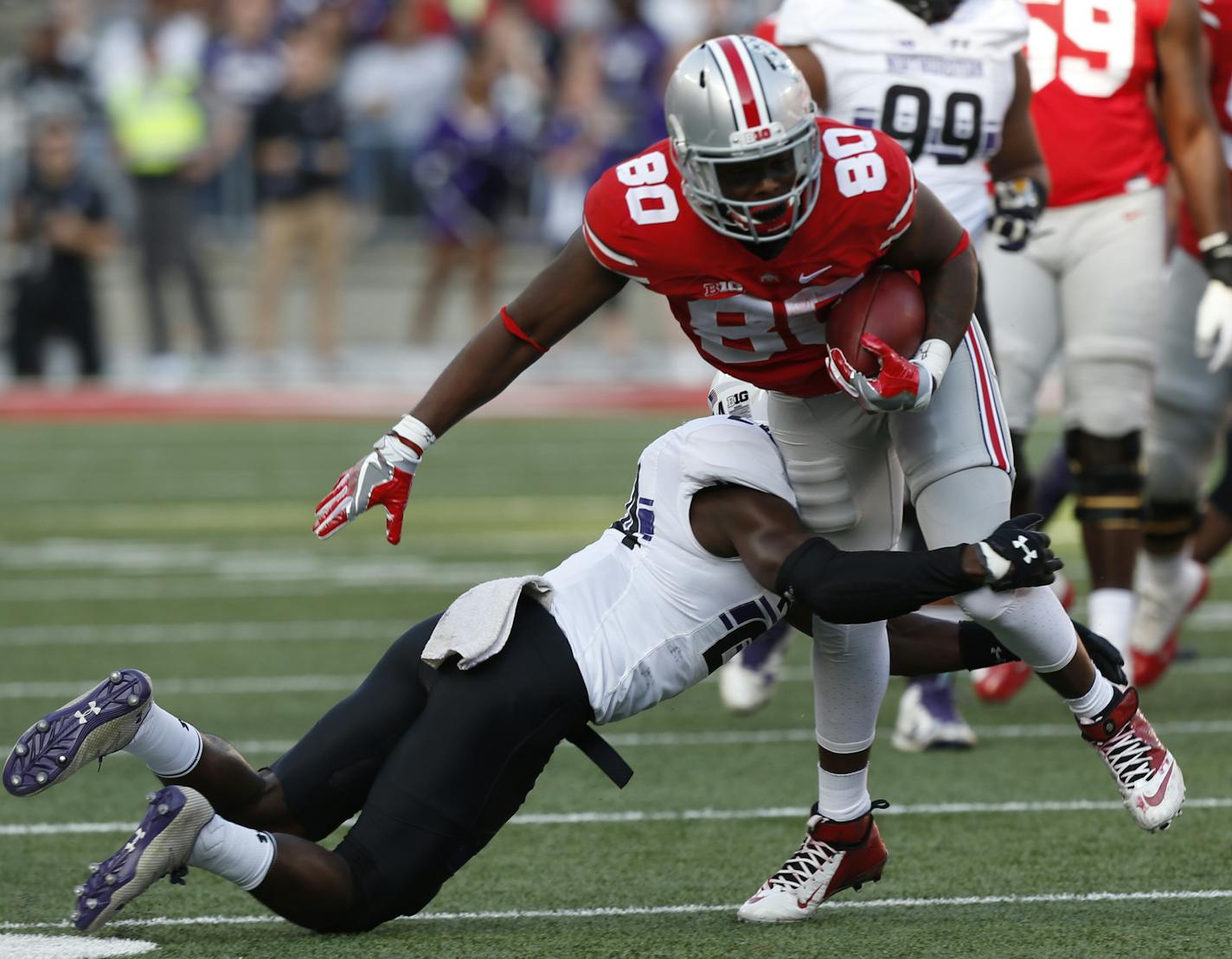 Northwestern defensive back Montre Hartage, left, tackles Ohio State wide receiver Noah Brown during the first half of an NCAA college football game Saturday, Oct. 29, 2016, in Columbus, Ohio. (AP Photo/Jay LaPrete)