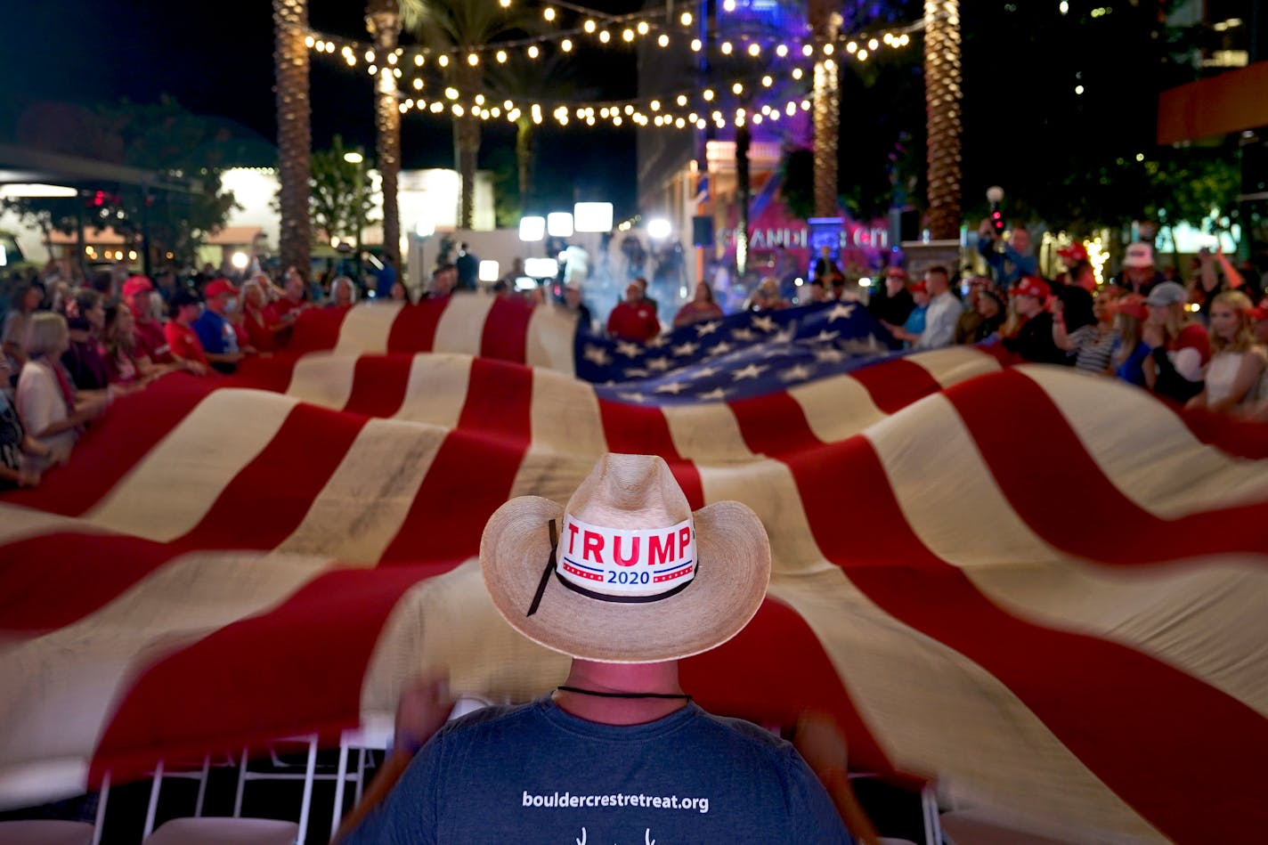 President Donald Trump supporters wave a flag during an election watch party Tuesday in Chandler, Ariz.