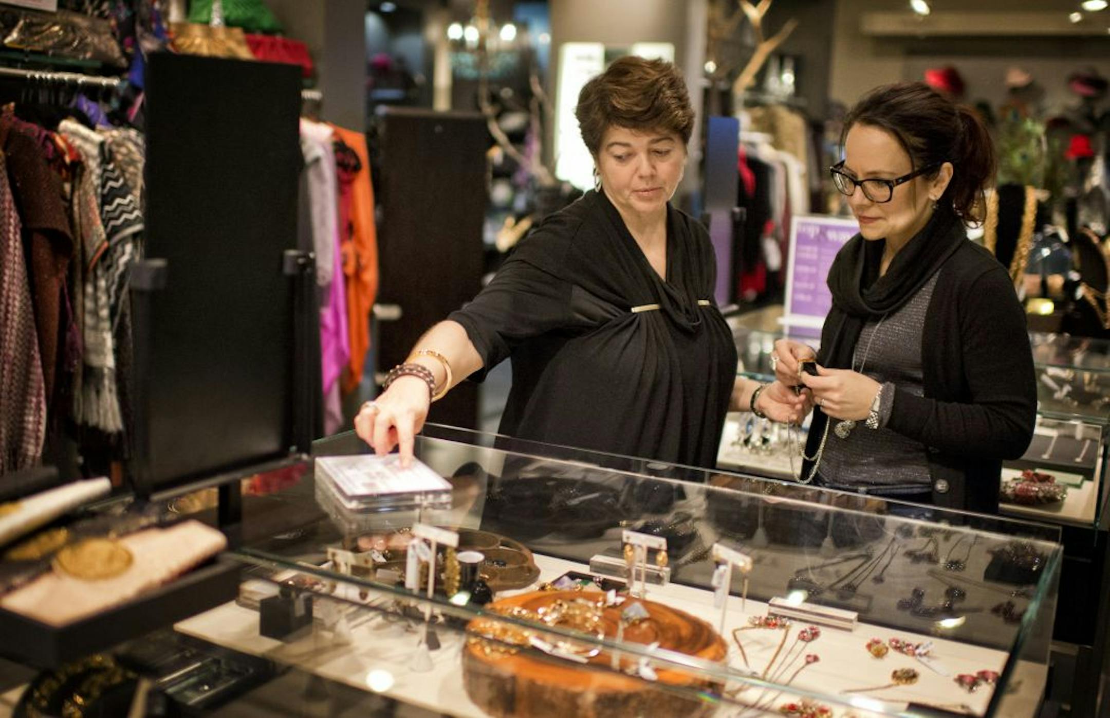 Anna Cohn, left helped customer Heike Drake-Cavalletti at Styled Life in the Galleria, Edina. Anna was hired a few months ago. The store also hired several other team members in the last few months. The U.S. economy added 146, 000 jobs last month and the retail sector has been one of the best performers Friday, December 7, 2012.