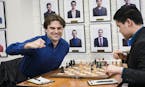 Sam Shankland, left, celebrates after his opponent, Awonder Liang, resigns in the final round Sunday and Shankland secures the title of U.S. chess cha