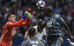 Minnesota United goalkeeper Vito Mannone (1) makes a save near teammate Ike Opara (3) dduring the second half of an MLS soccer match against the Vanco