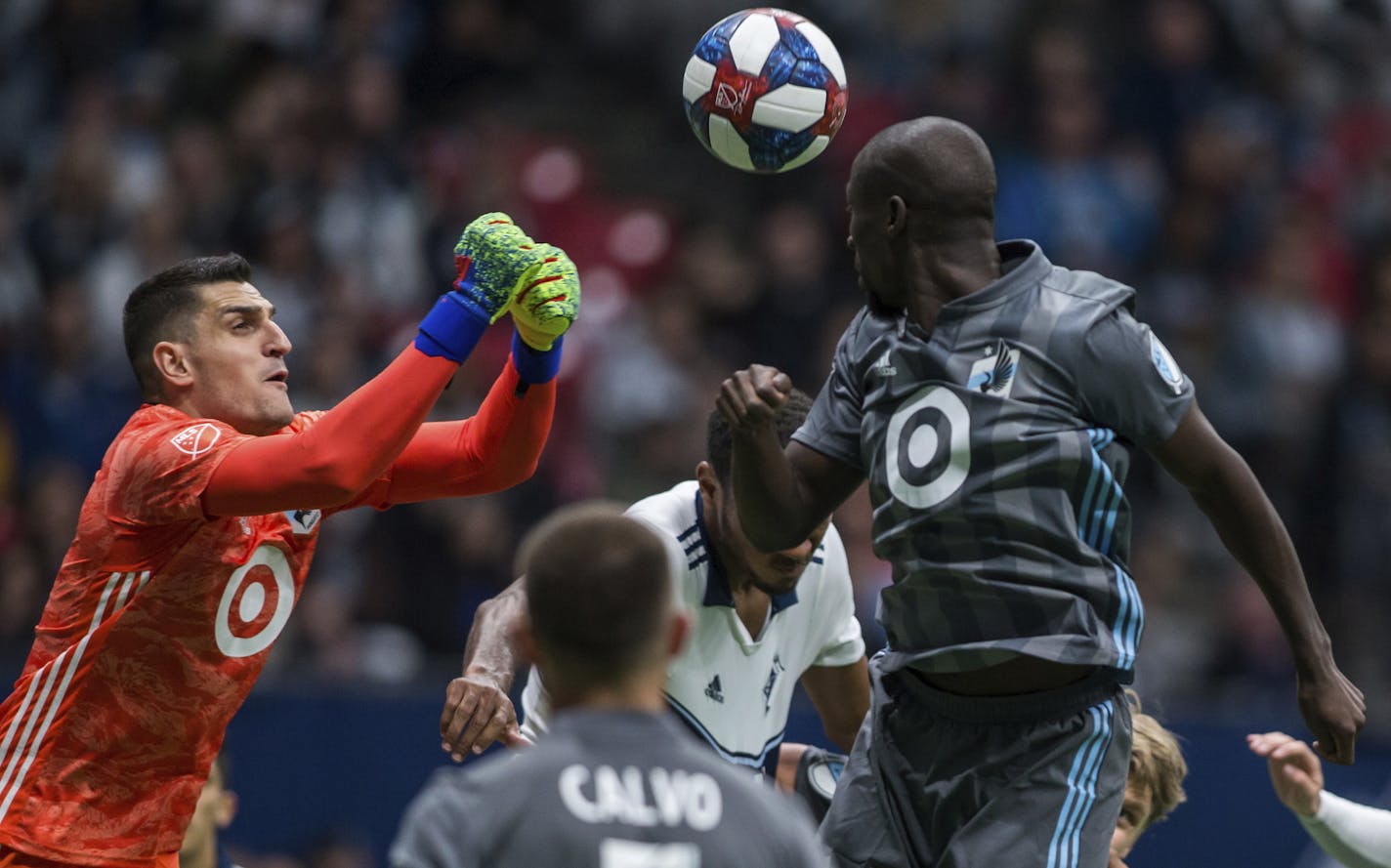 Minnesota United goalkeeper Vito Mannone (1) makes a save near teammate Ike Opara (3) dduring the second half of an MLS soccer match against the Vancouver Whitecaps on Saturday, March 2, 2019, in Vancouver, British Columbia. (Ben Nelms/The Canadian Press via AP)