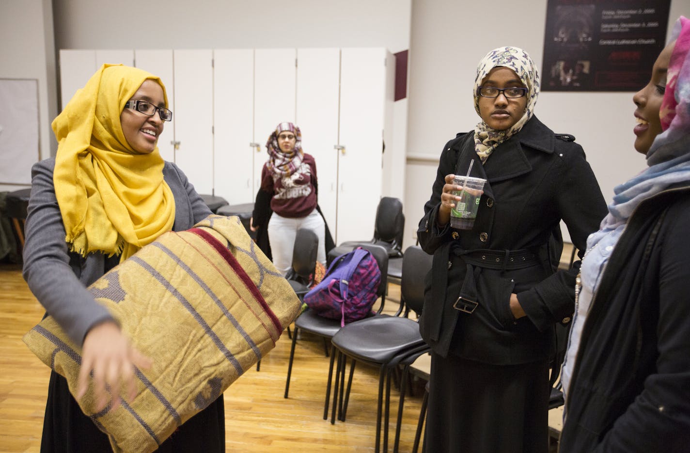 Fardosa Hassan, left, the Muslim student advisor with Campus Ministry at Augsburg College, talks with Samira Osman, from right, 20, the public relations officer for the Muslim Student Association (MSA), and Amal Warsame, 22, an MSA member, after student-led Friday prayer at Augsburg College in Minneapolis on Friday, February 19, 2016. ] (Leila Navidi/Star Tribune) leila.navidi@startribune.com