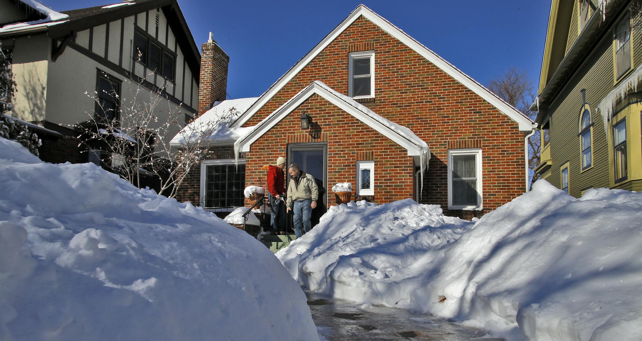 Marcy Wengler is a real estate agent in St. Paul who has found difficulty selling houses this winter due to the harsh weather conditions. She has responded by making cookies and coffee for those that endure the snow and cold to tour her sale homes. Snow was piled up around a St. Paul home that was the subject of a recent Wengler's open house. (MARLIN LEVISON/STARTRIBUNE(mlevison@startribune.com)