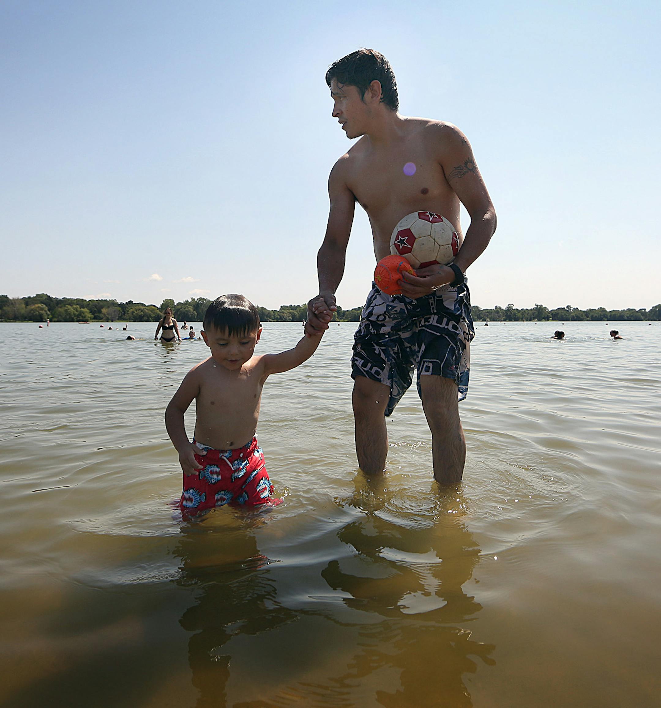 Jose Noria, Minneapolis, enjoyed playing in the cool waters of Lake Nokomis on a hot, August afternoon with his son, Kaled, 2. ] JIM GEHRZ ï james.gehrz@startribune.com / Minneapolis, MN / August 14, 2015 / 1:00 PM ñ BACKGROUND INFORMATION: Warm weather, with temps in the 90s. (cq Kaled by dad, Jose).