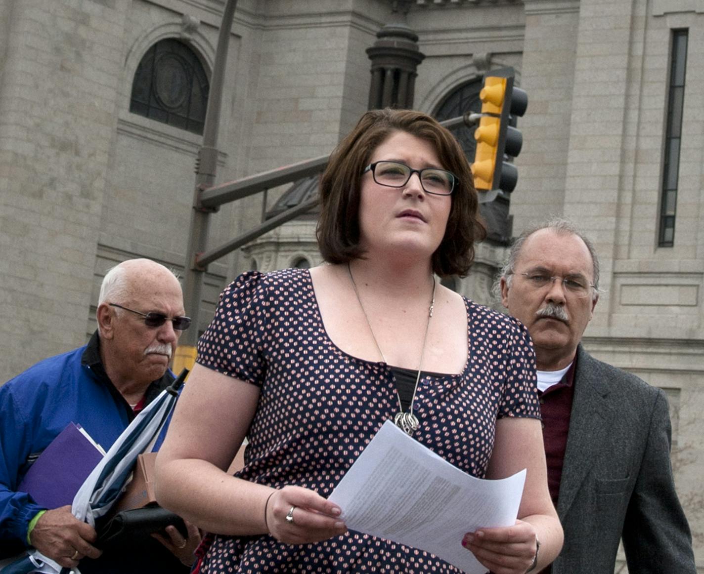 Megan Peterson, 22, delivered a letter to the Archdiocese of St. Paul asking bishops to help find other victims of Fr. Joseph Jeyapaul, a catholic priest who raped her when she was 14 in Greenbush, MN, She is accompanied by other SNAP members Frank Meuers, left and state director Bob Schwiderski, right, Thursday, March 22, 2012. ] GLEN STUBBE * gstubbe@startribune.com EDS: SNAP is the Survivors Network of those Abused by Priests (SNAPnetwork.org)