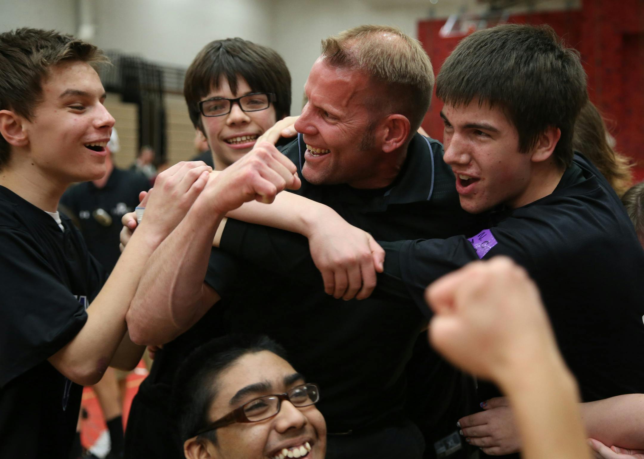 The Mustang team celebrate their state championship win with their coach Pete Kutches. ] (KYNDELL HARKNESS/STAR TRIBUNE) kyndell.harkness@startribune.com Anoka -Hennepin Mustangs vs the Rochester Raiders in the adapted softball championship PI division in Coon Rapids Min., Friday, May 30, 2015.