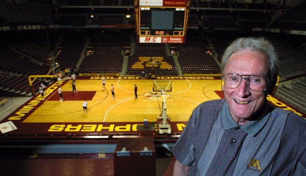 Ray Christensen in his broadcasting perch in an almost empty Williams Arena in 2001.