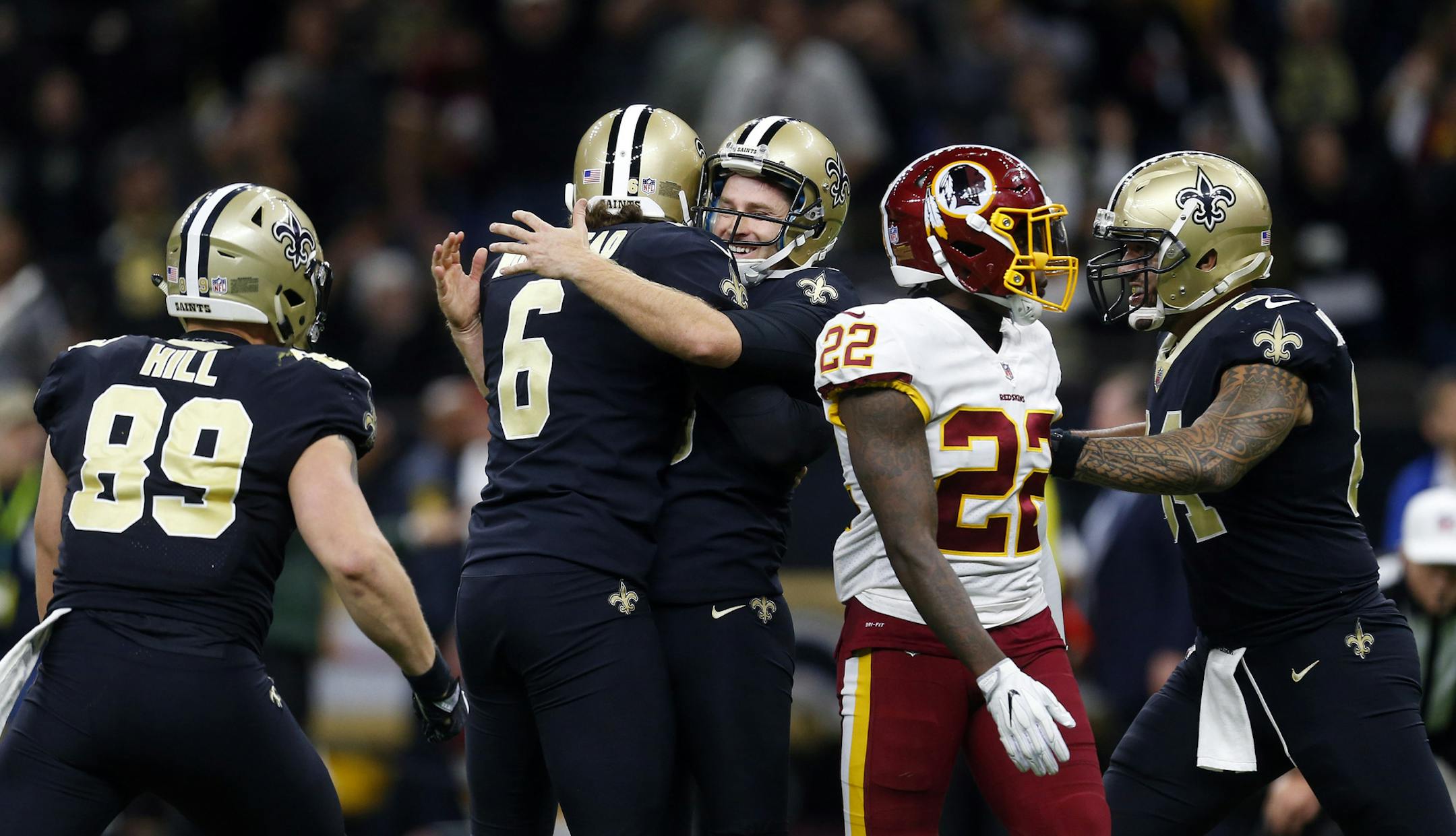 New Orleans Saints kicker Wil Lutz, center, celebrates his game winning field goal with holder Thomas Morstead (6) and other teammates, during overtime of an NFL football game against the Washington Redskins in New Orleans, Sunday, Nov. 19, 2017. The Saints won 34-31.(AP Photo/Butch Dill)