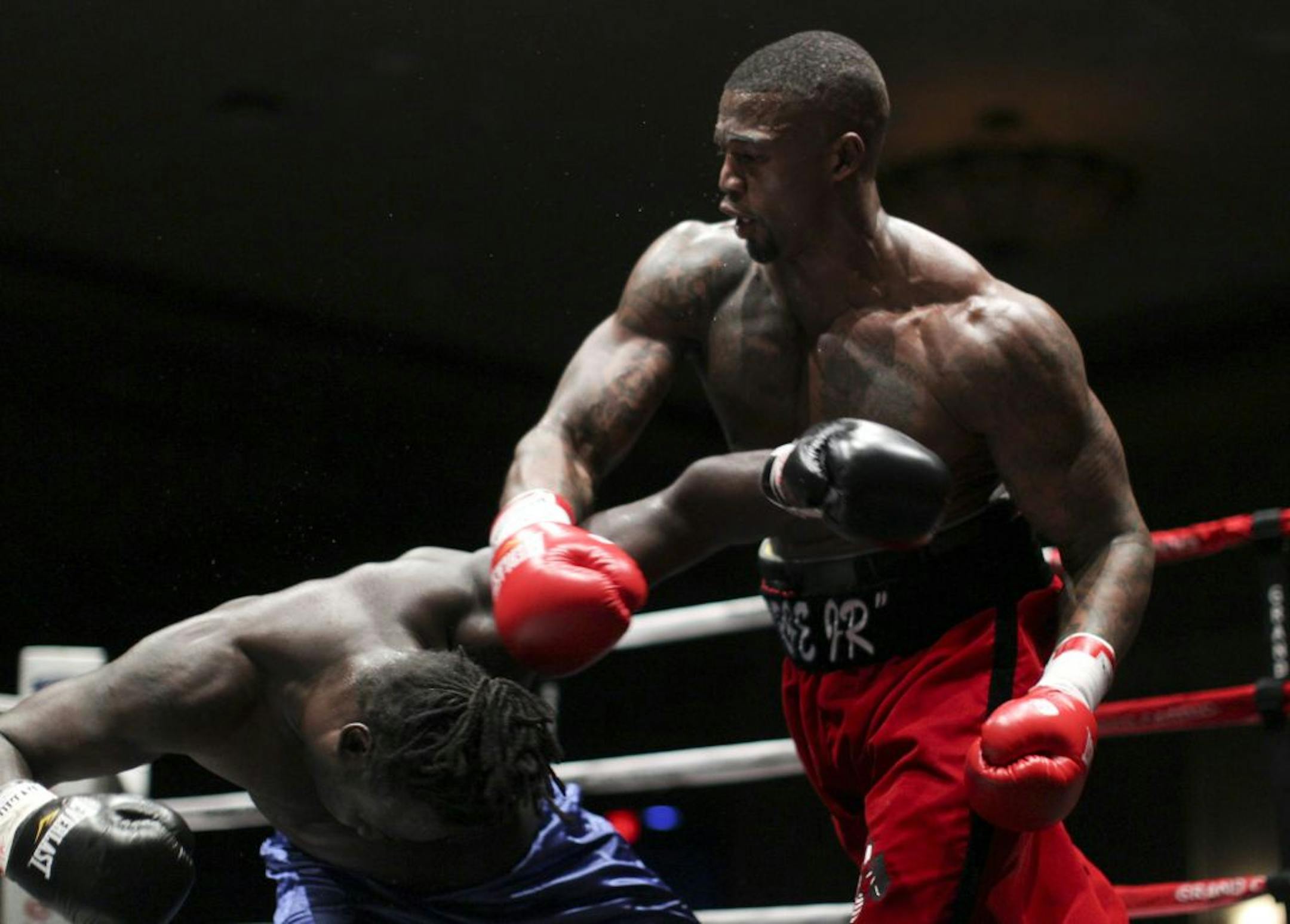 Ray Edwards landed a blow to T.J. Gibson on his way to winning his professional boxing debut.