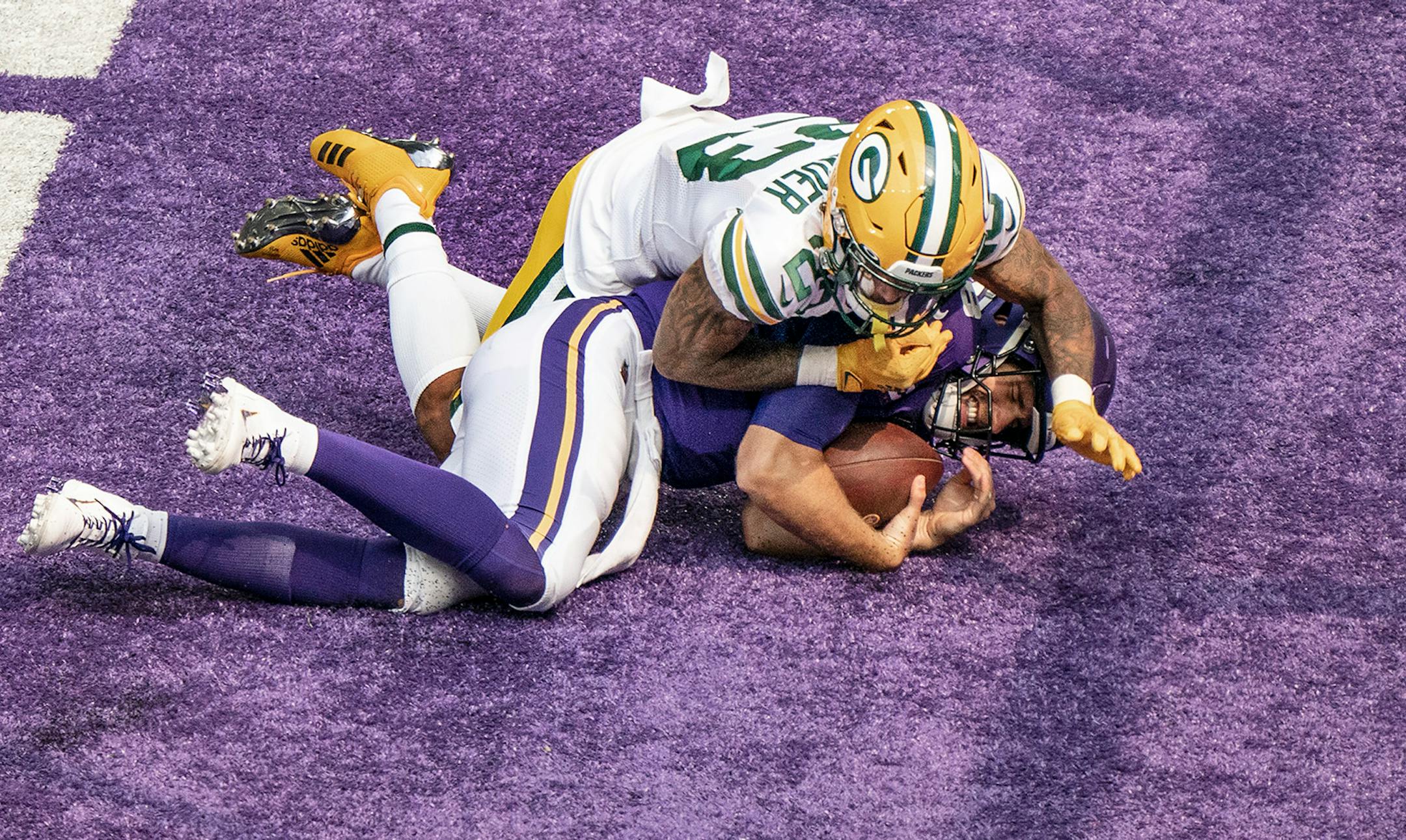 Packers cornerback Jaire Alexander sacked Minnesota Vikings quarterback Kirk Cousins (8) in the endzone for a safety in the second quarter.