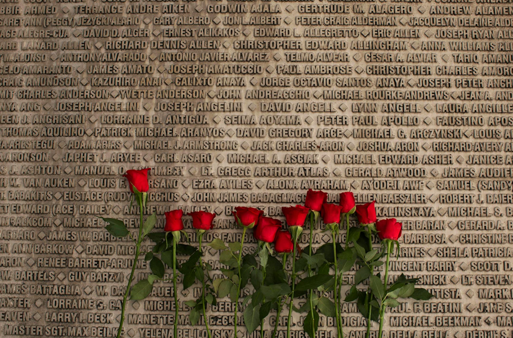 Red roses are placed next to names names of victims of the Sept. 11, 2001 terrorist attacks on the U.S. at a memorial site during a ceremony marking the 12th anniversary of 9/11 outside Jerusalem, Wednesday, Sept. 11, 2013.