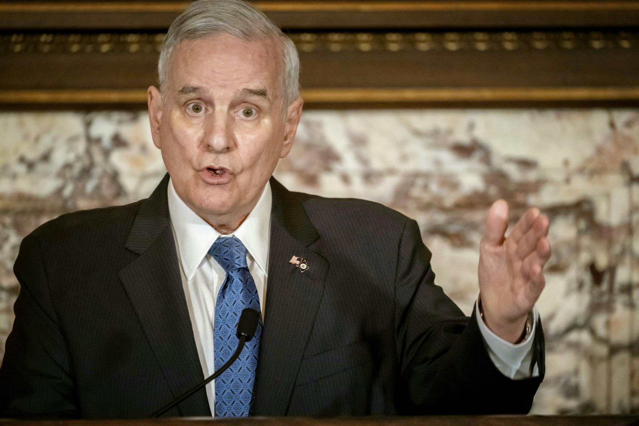 In this May 23, 2018, file photo, Minnesota Gov. Mark Dayton speaks at a press conference in St. Paul. Dayton says he expects to be home before Thanksgiving after complications from back surgery required more than a month of hospitalization.