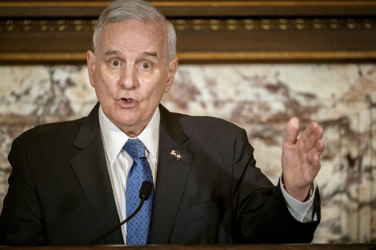 In this May 23, 2018, file photo, Minnesota Gov. Mark Dayton speaks at a press conference in St. Paul. Dayton says he expects to be home before Thanksgiving after complications from back surgery required more than a month of hospitalization.