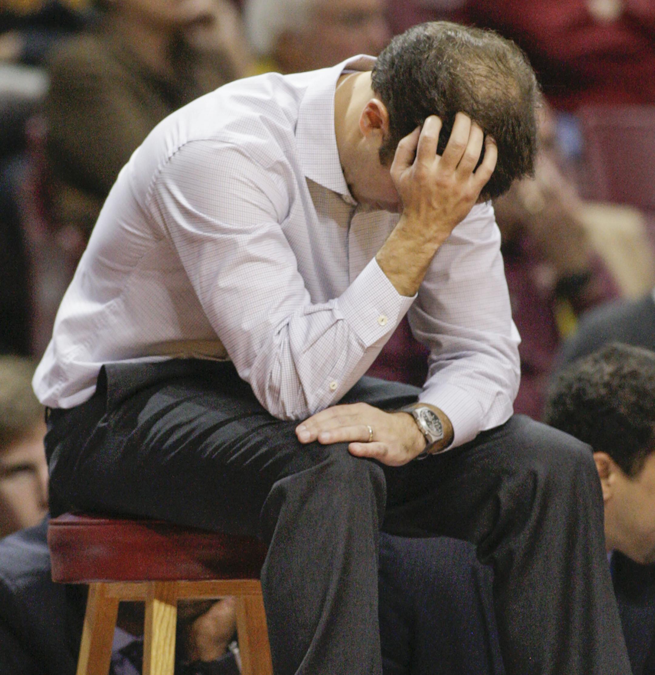 Minnesota head coach Richard Pitino holds his head near the end Minnesota's 85-81 double-overtime loss to South Dakota during an NCAA college basketball game, Saturday, Dec. 5, 2015, in Minneapolis. (AP Photo/Paul Battaglia)