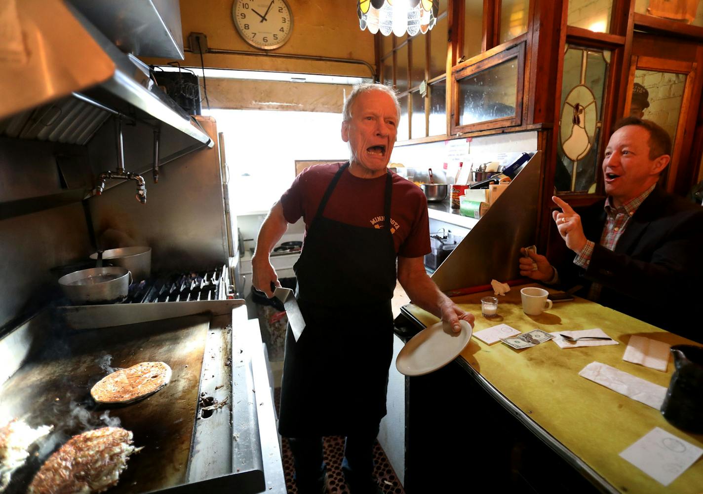 With his usual animation, Doug Grina, in the middle of pancake duty, confirms an order at Al's Breakfast.