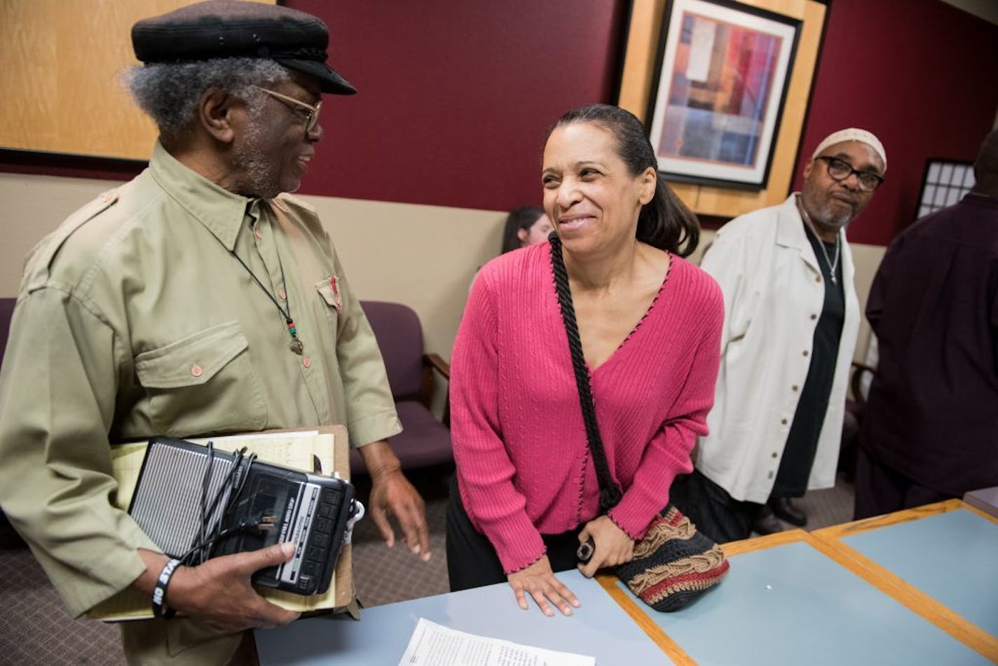 Retired Macalester College professor Mahmoud El-Kati, left, visits with Kim Ellison after the monthly meeting of The Nu Skool of Afrikan American Thought at the Golden Thyme Cafe in Saint Paul Friday, April 22, 2016.