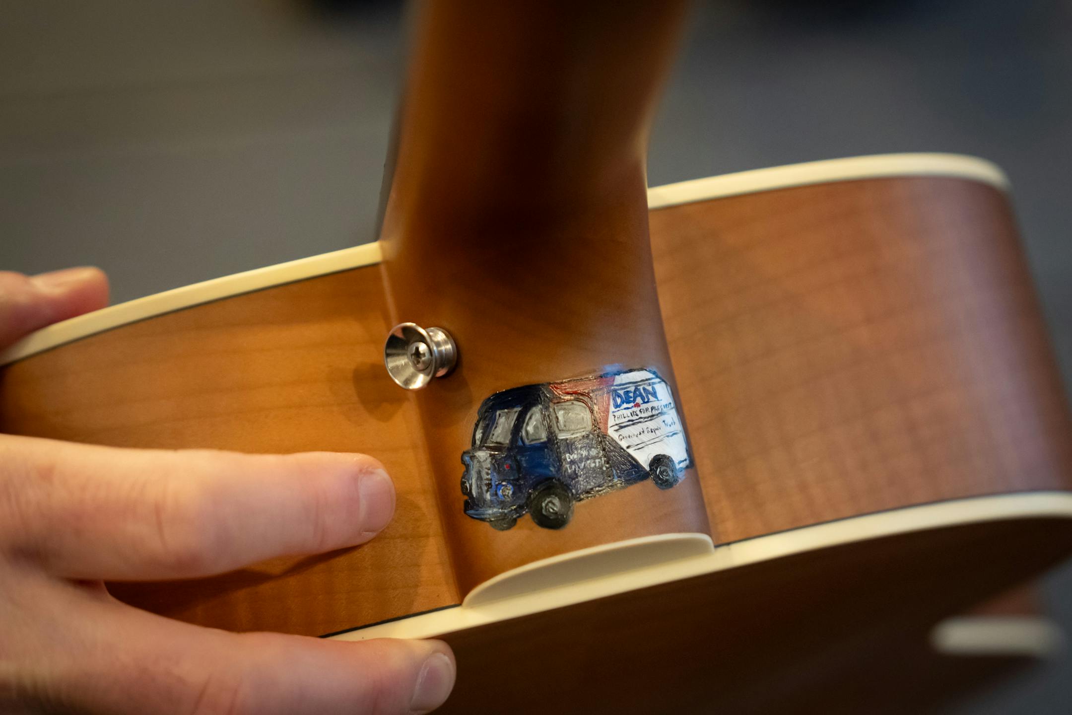 Dean Phillips pulled out a guitar in New Hampshire campaign headquarters, it is a gift from his daughter Pia where she painted a small Government Repair Truck on the top Friday, Jan. 19, 2024  Manchester, New Hampshire.    ] GLEN STUBBE • glen.stubbe@startribune.com