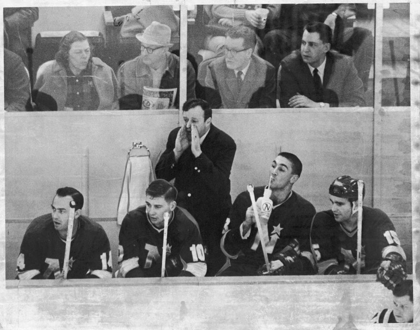 Minnesota North Stars hockey,1968. Rest period for (left to right) MacDonald, Cullen, Collins, Boudrias. Collins drinks water while coach Wren Blair yells instructions. Minneapolis STAR (now Star Tribune) photo March 7, 1968, by Larry Schreiber.