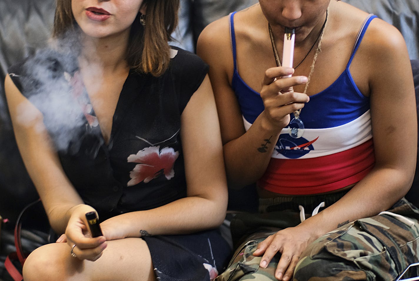 FILE - In this June 8, 2019, file photo, two women smoke cannabis vape pens at a party in Los Angeles. California officials announced Monday, Jan. 27, 2020, that marijuana vape cartridges seized in illegal shops in Los Angeles contained potentially dangerous additives, including a thickening agent blamed for a national outbreak of deadly lung illnesses tied to vaping. (AP Photo/Richard Vogel)