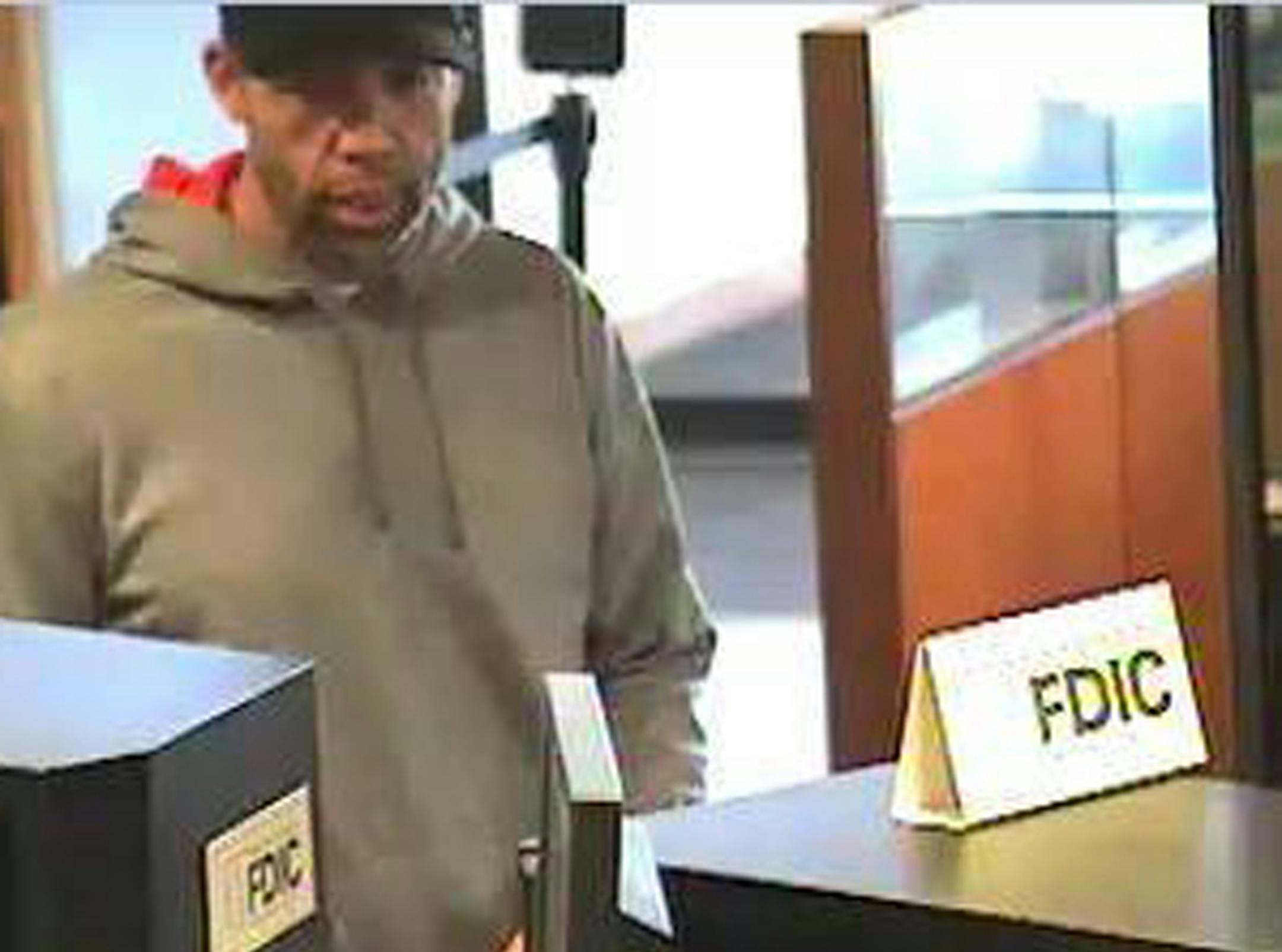 Caption: This man, shown in surveillance images robbing a Maple Grove bank Tuesday, also hit a bank about 90 minutes earlier in Burnsville. Credit: Provided by Maple Grove police