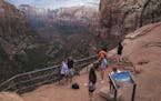 FILE &#xf3; Visitors at the Canyon Overlook in Zion National Park in southwest Utah, Aug. 13, 2017. A Trump administration proposal to steeply increas