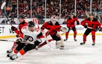 Flyers defenseman Sean Walker (26) skates with puck in the second period of an NHL Winter Classic hockey game against the New Jersey Devils in East Ru