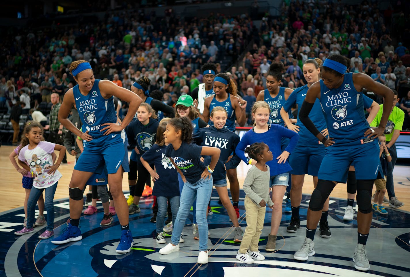 The Lynx players, including forward Napheesa Collier, left, did a post-game victory dance with young fans after a game in 2019.