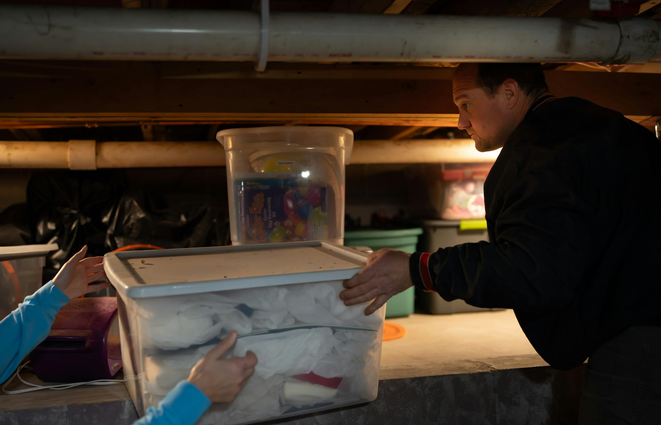 Ben Johnson pulled boxes of Christmas decorations from the crawl space that is part of the basement in their family home in Kenyon.
Kenyon, Minn., Wednesday December 10, 2025 


Glen Stubbe for The Minnesota Star Tribune