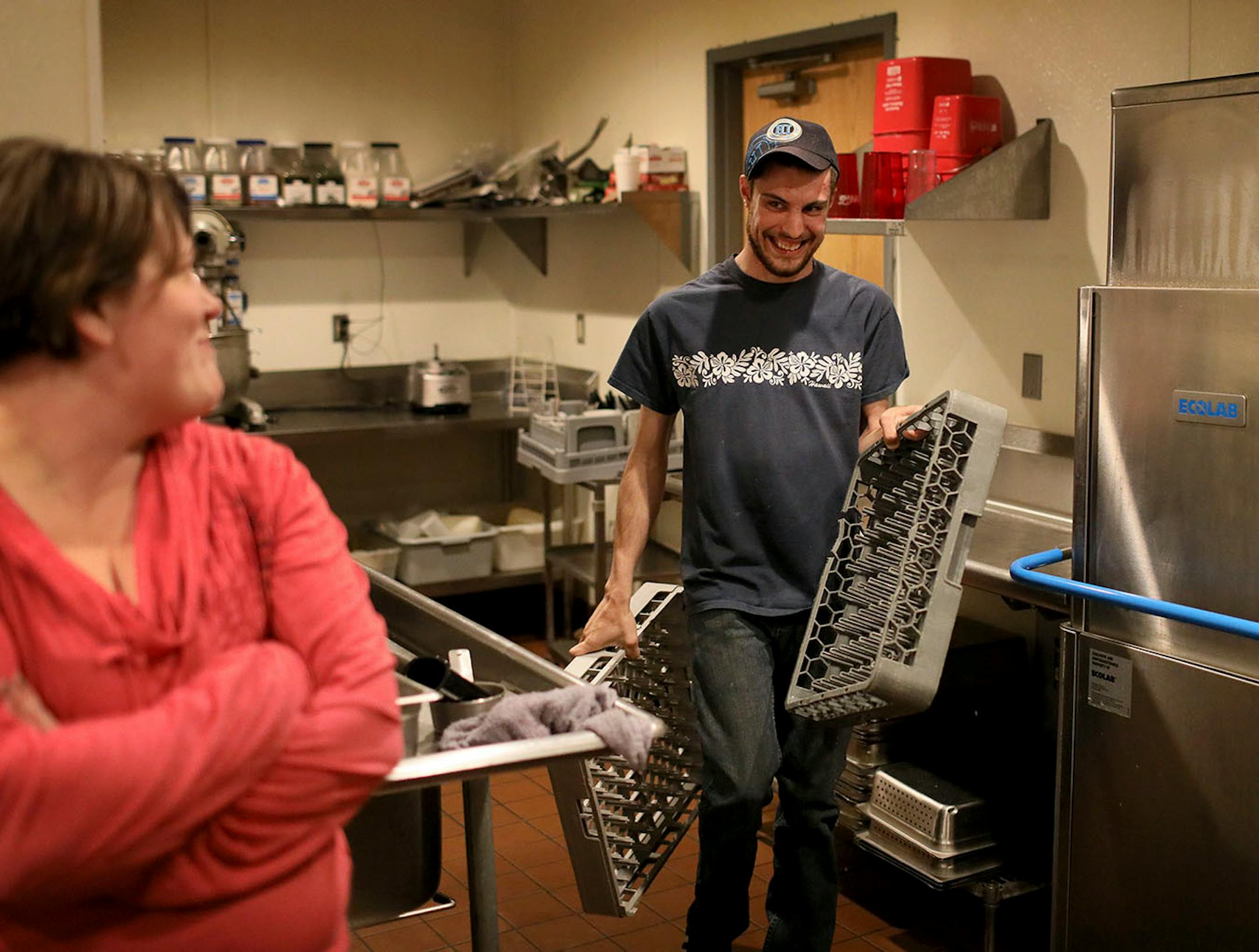 Chris McIntire washes dishes with his job coach Jaime Klatt looking on Friday, May 11, 2018, at the Friendly Buffalo Restaurant in Big Lake, MN.