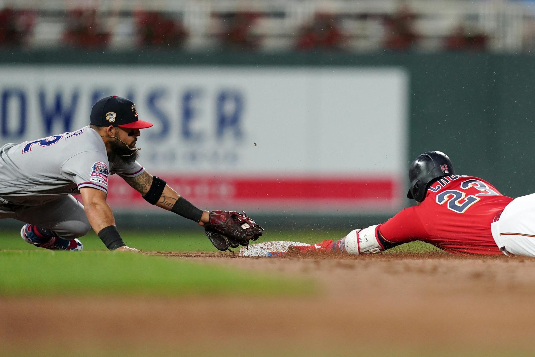 Minnesota Twins designated hitter Nelson Cruz (23) beat Texas Rangers second baseman Rougned Odor (12) to the tag at second base after he hit a double in the second inning.