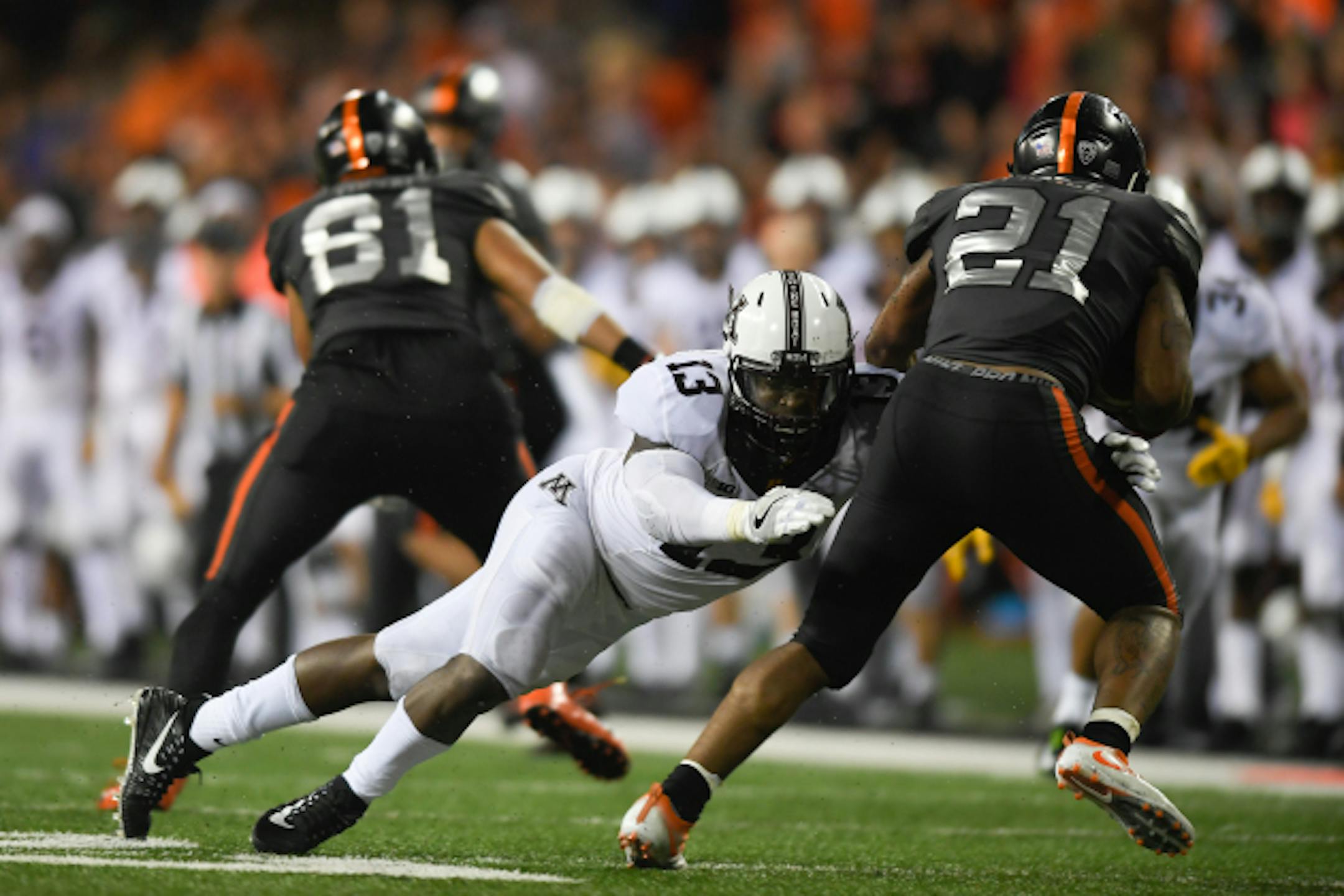 Minnesota Golden Gophers linebacker Jonathan Celestin (13) tackled Oregon State Beavers running back Artavis Pierce (21) for his second tackle in a row in the third quarter.  ] AARON LAVINSKY ' aaron.lavinsky@startribune.com