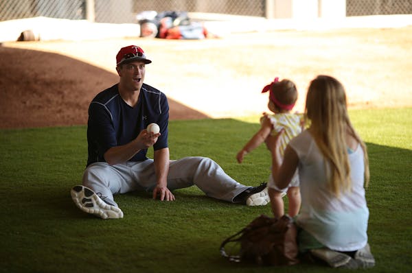 Twins pitcher Kyle Gibson played with his daughter, Hayden, with his wife, Elizabeth, in the bullpen after working out Tuesday morning at Hammond Stad